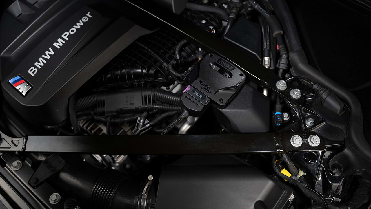 RaceChip GTS 5 control unit installed in the engine bay of a BMW M Power vehicle.